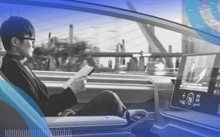 self-driving car image of a person in a theoretical rendering of a self-driving car reading a book